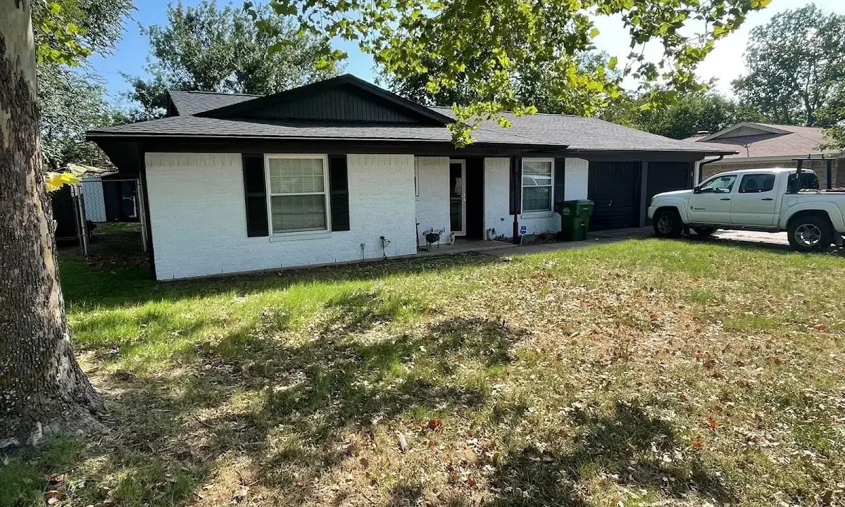 Professional roofing crew working on a residential roof in St. James